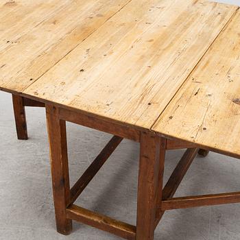 A pine gateleg table, 19th Century.