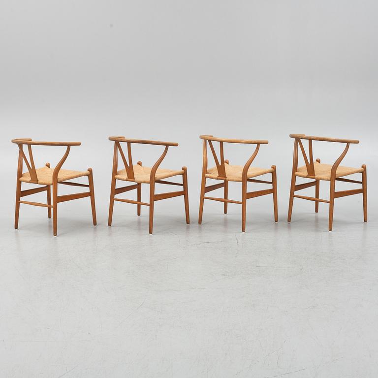 Hans J Wegner, a set of four model CH-24 ”Wishbone” chairs, Carl Hansen & Son, Odense, Denmark.