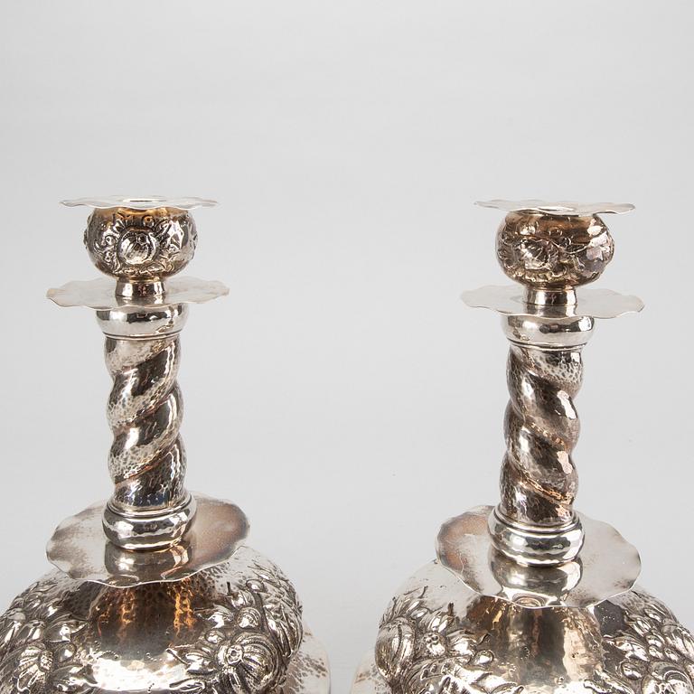 A pair of silver baroquestyle candlesticks. W.H.H, Stockholm. 1935. Filled foot.