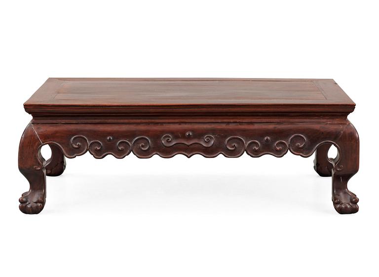 A hardwood 'claw on ball' low table, Qing dynasty.