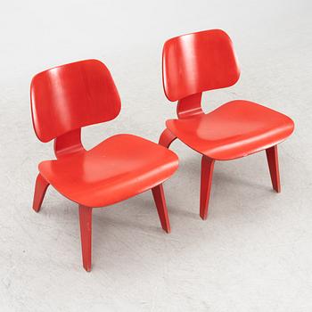 Charles & Ray Eames, a pair of 'LCW' armchairs, Vitra, dated 2003.