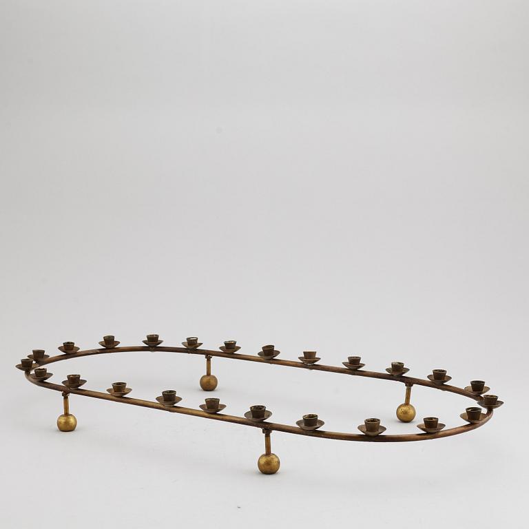 A mid 20th Century brass candle ring.