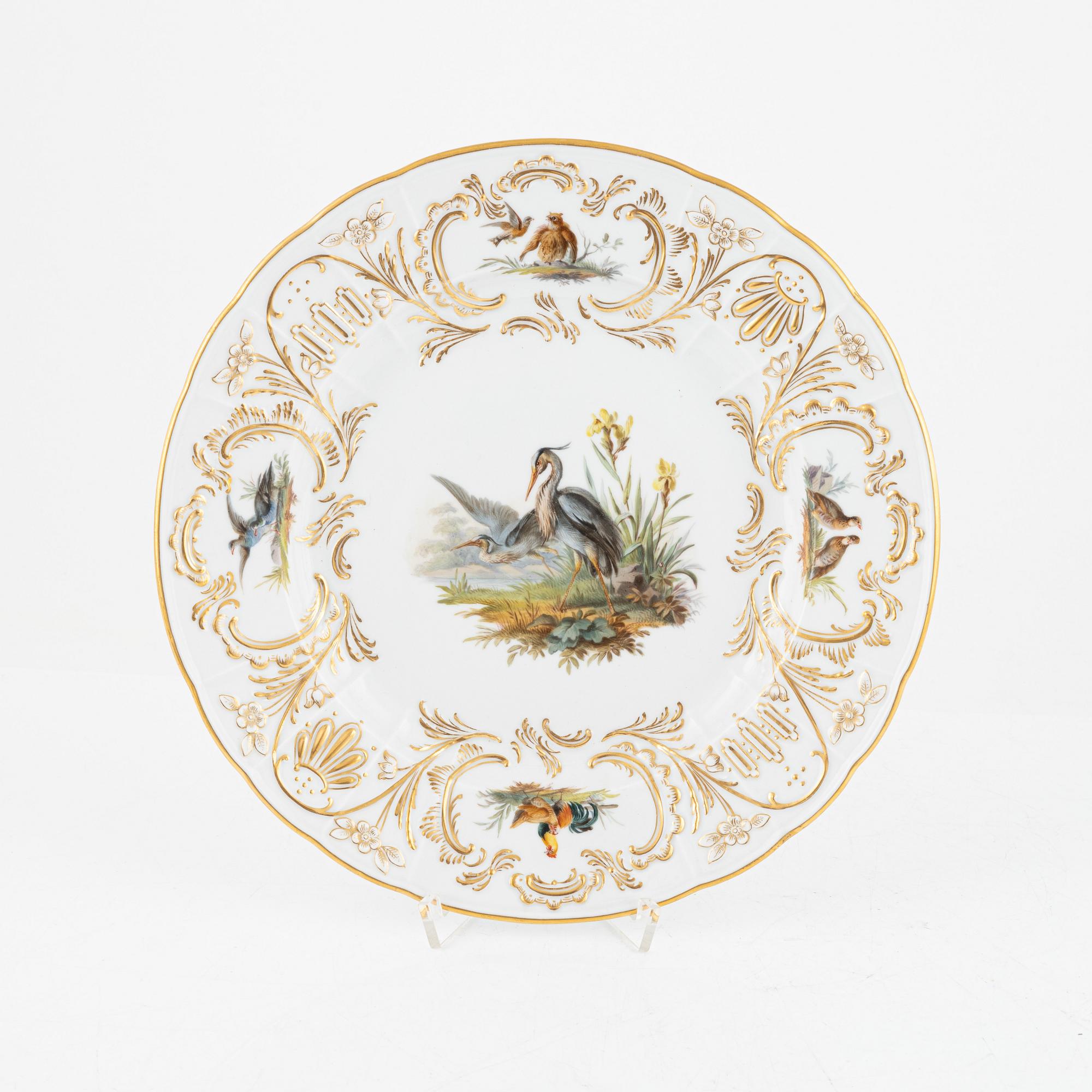 A set of five Meissen porcelain games plates, late 19th to early 20th century.