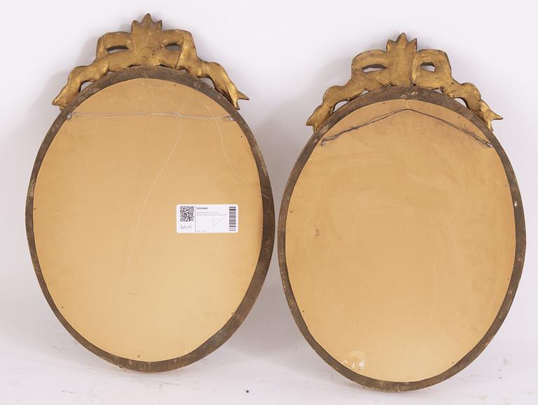 A pair of Gustavian style giltwood and parcel-gilt mirrors from around year 1900.
