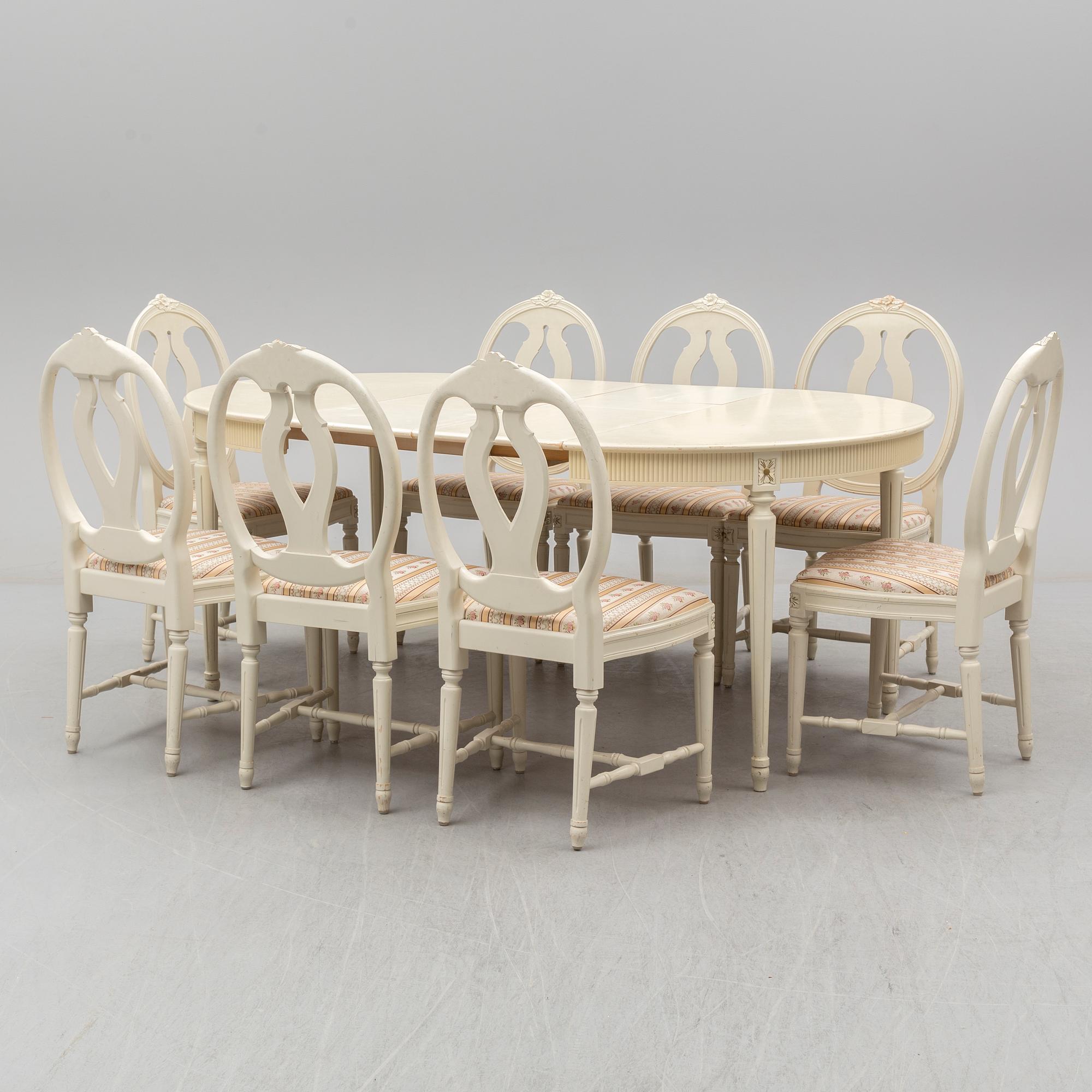 A set of eight chairs and a dining table. Gustavian style, second half of the 20th century. 2 leaves included.