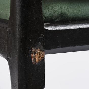 A set of eight black Swedish rococo chairs.