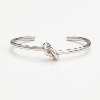 Céline, A "Knot" bracelet made of silver coloured metal. Marked Celine, C3 UCA0119 Made in Italy.