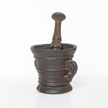 A cast-iron mortar and pestle of renaissance-type, 17th century.
