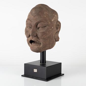 A carved stone head of a Luohan, Ming style but later.