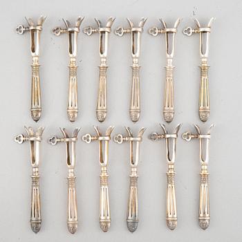 A set of six French silver pork chop holders, circa 1900.