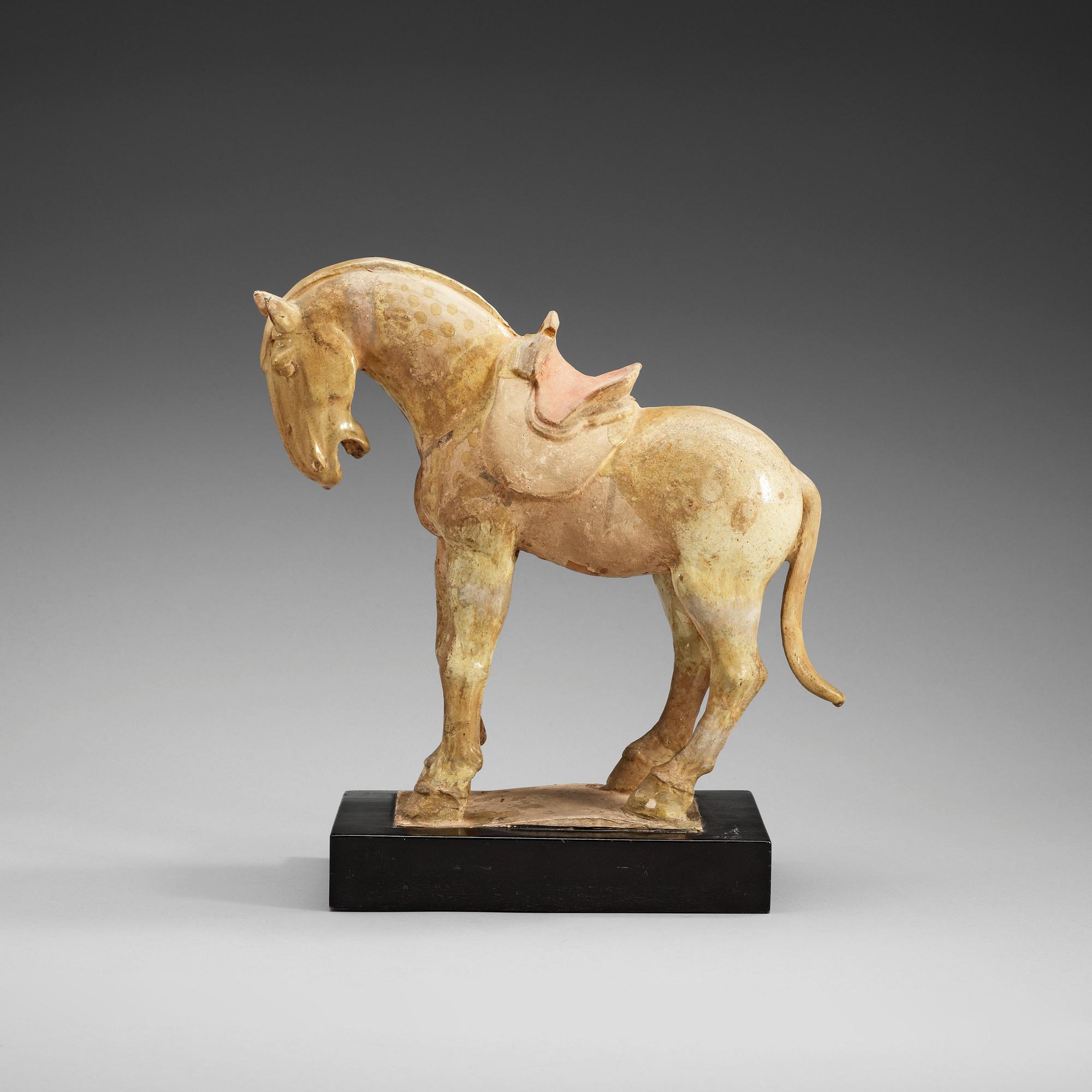 A yellow glazed pottery figure of a horze, presumably Tang dynasty (618-907).