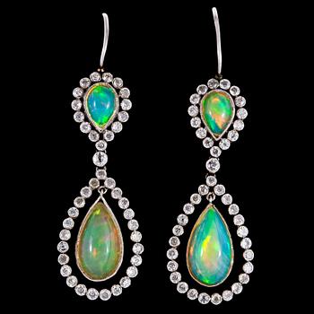 1133. A pair of opal and diamond earrings, tot. app 0.90 cts.
