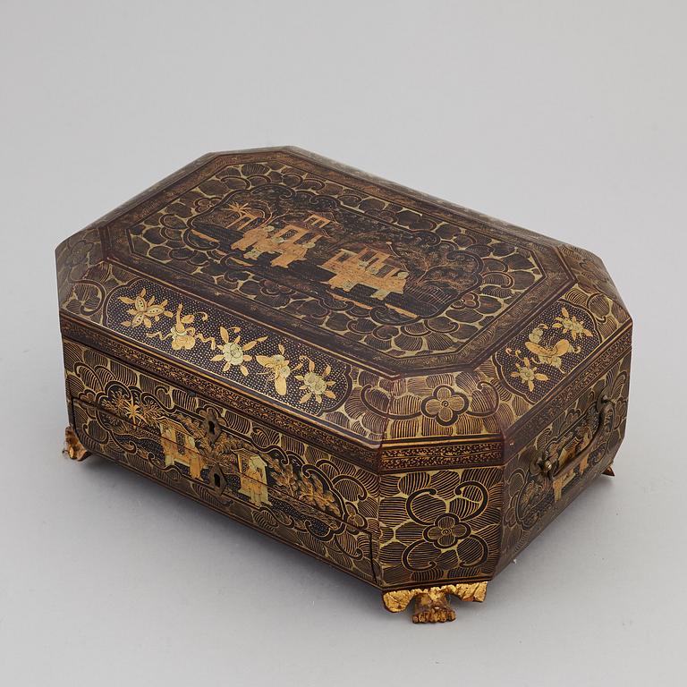 A lacquered sewing cabinet, Qing dynasty, 19th century.