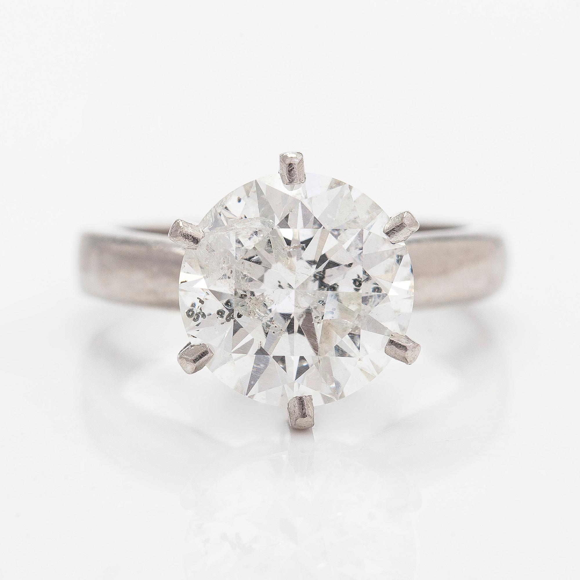 A platinum ring, with a brilliant-cut diamond approximately 3.10 ct. Domino Jewellery, Birmingham, England.