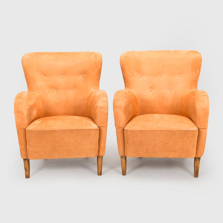 A pair of mid-20th century armchairs.