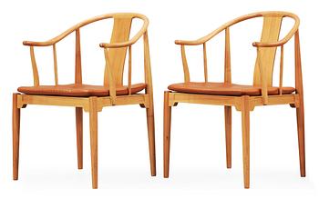 76. A pair of Hans J Wegner cherry and brown leather 'China chairs', Fritz Hansen, Denmark 1989.
