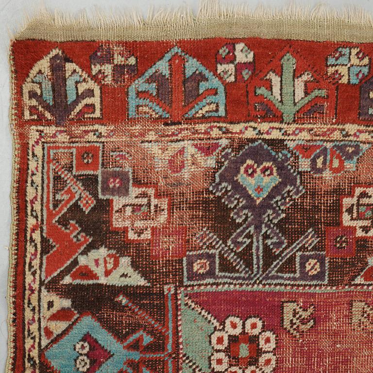 A RUNNER, an antique Anatolian, ca 425 x 101-107 cm (as well as 2,5 cm light green flat weave at one end).