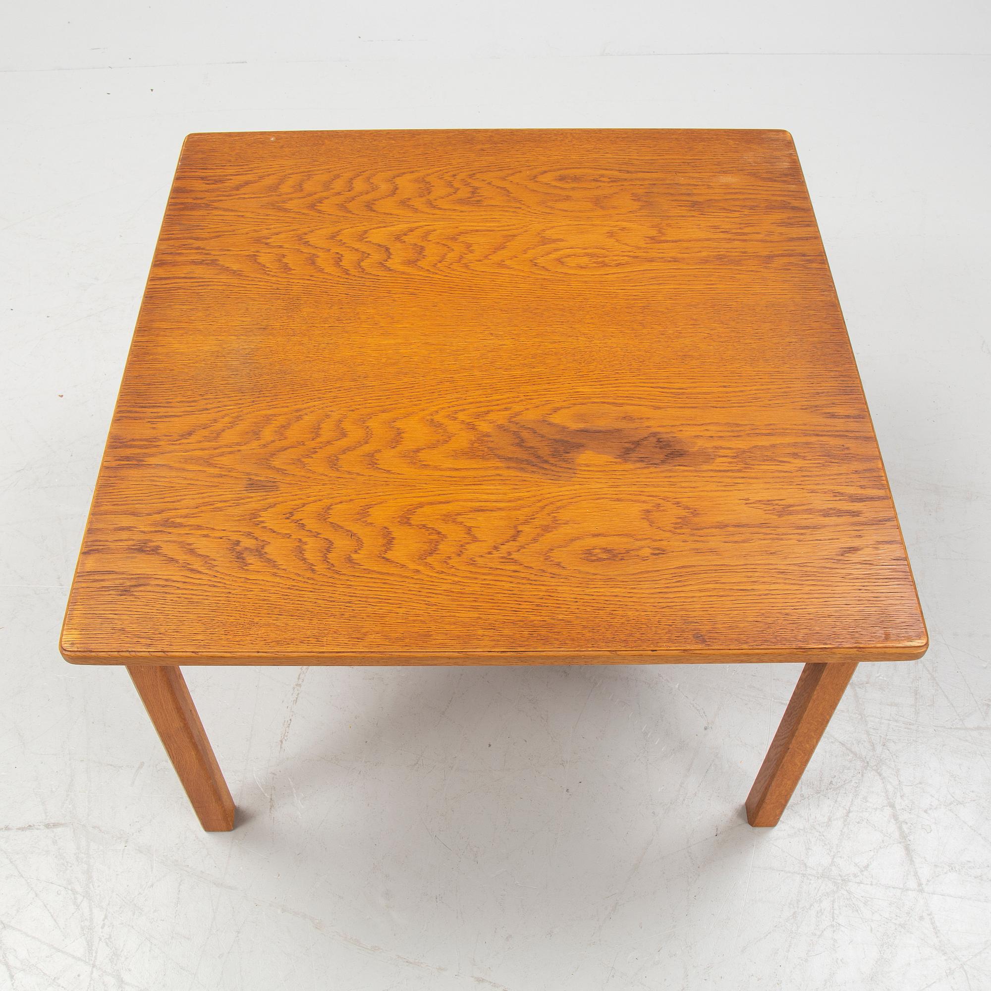 An oak coffee table with a later travertine top.