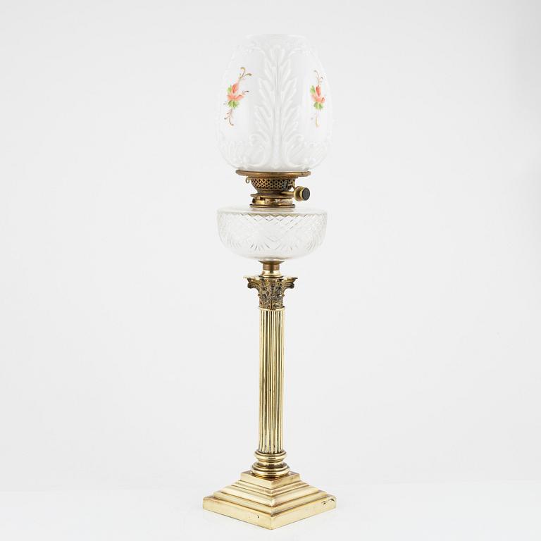 A brass and glass column shaped paraffin lamp, end of the 19th Century.