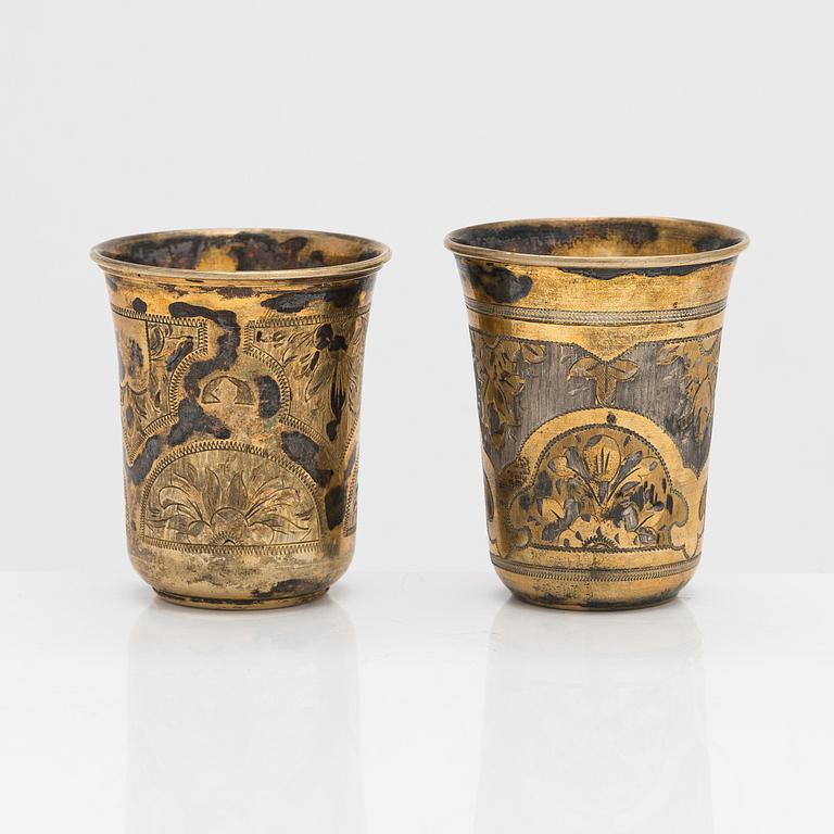 Four parcel-gilt silver beakers, Moscow 1870, 1876 and 1890.