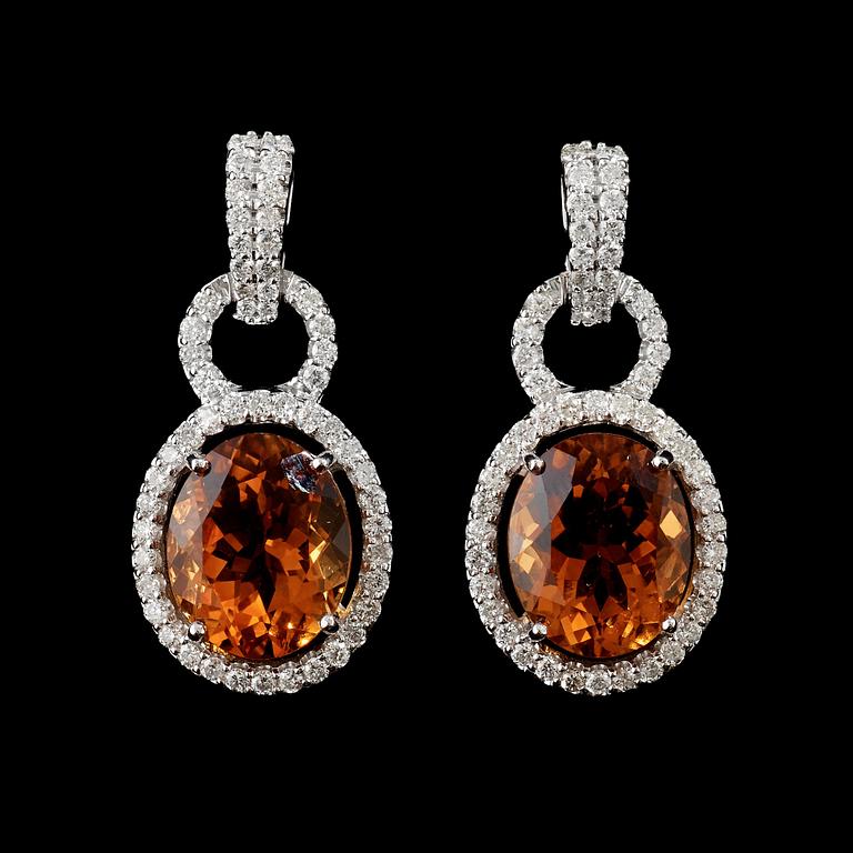 A pair of citrine and diamond earrings.