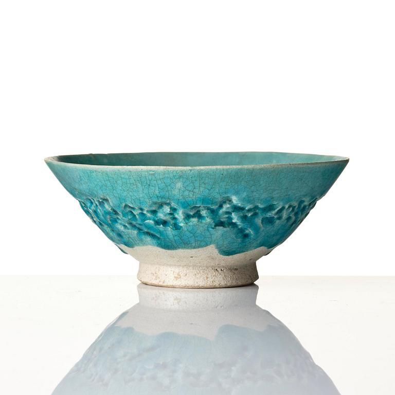 A Kashan Turquoise glazed conical pottery bowl, central Persia, 13th century.