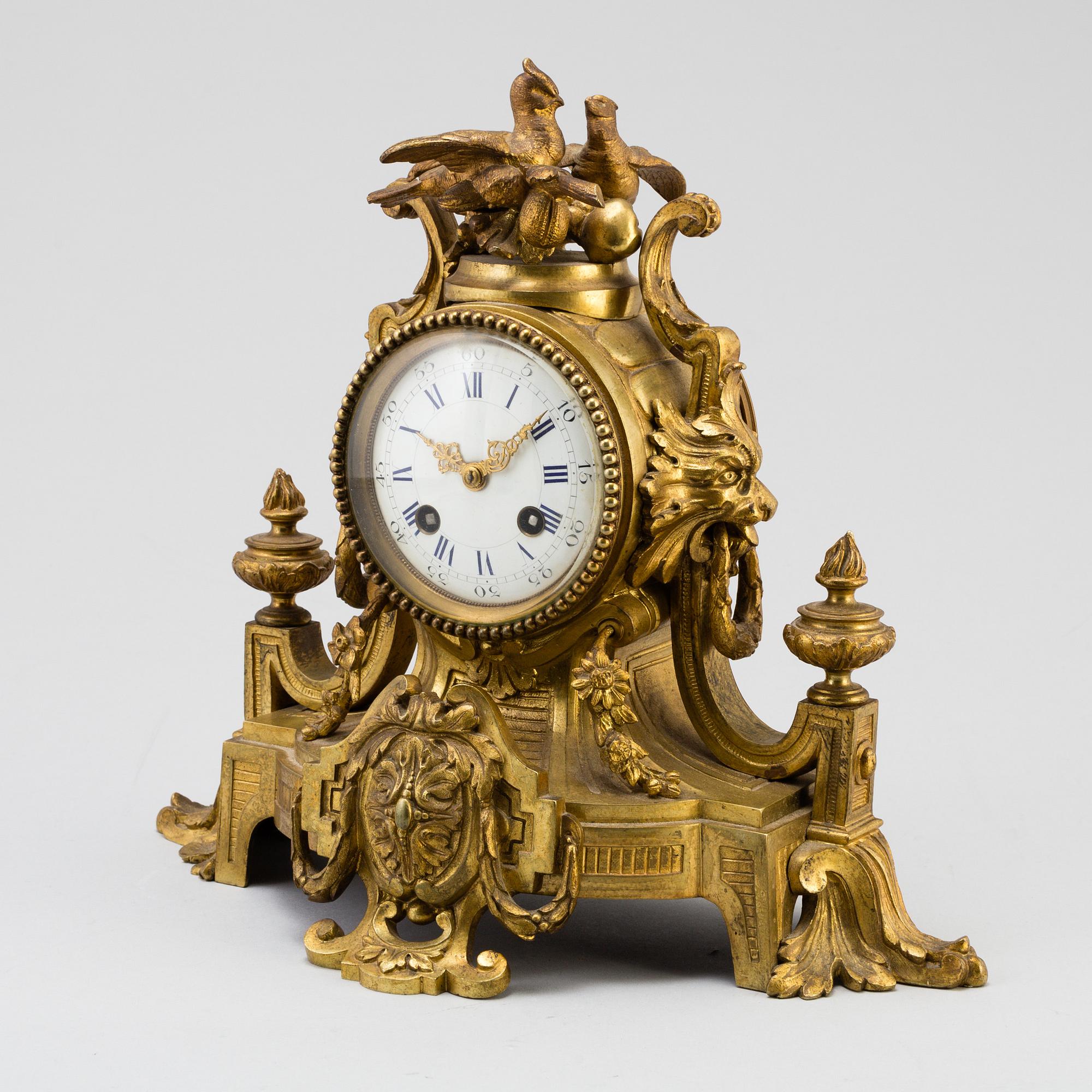 A table CLOCK and a pair of candelabra, second part of 19th century.