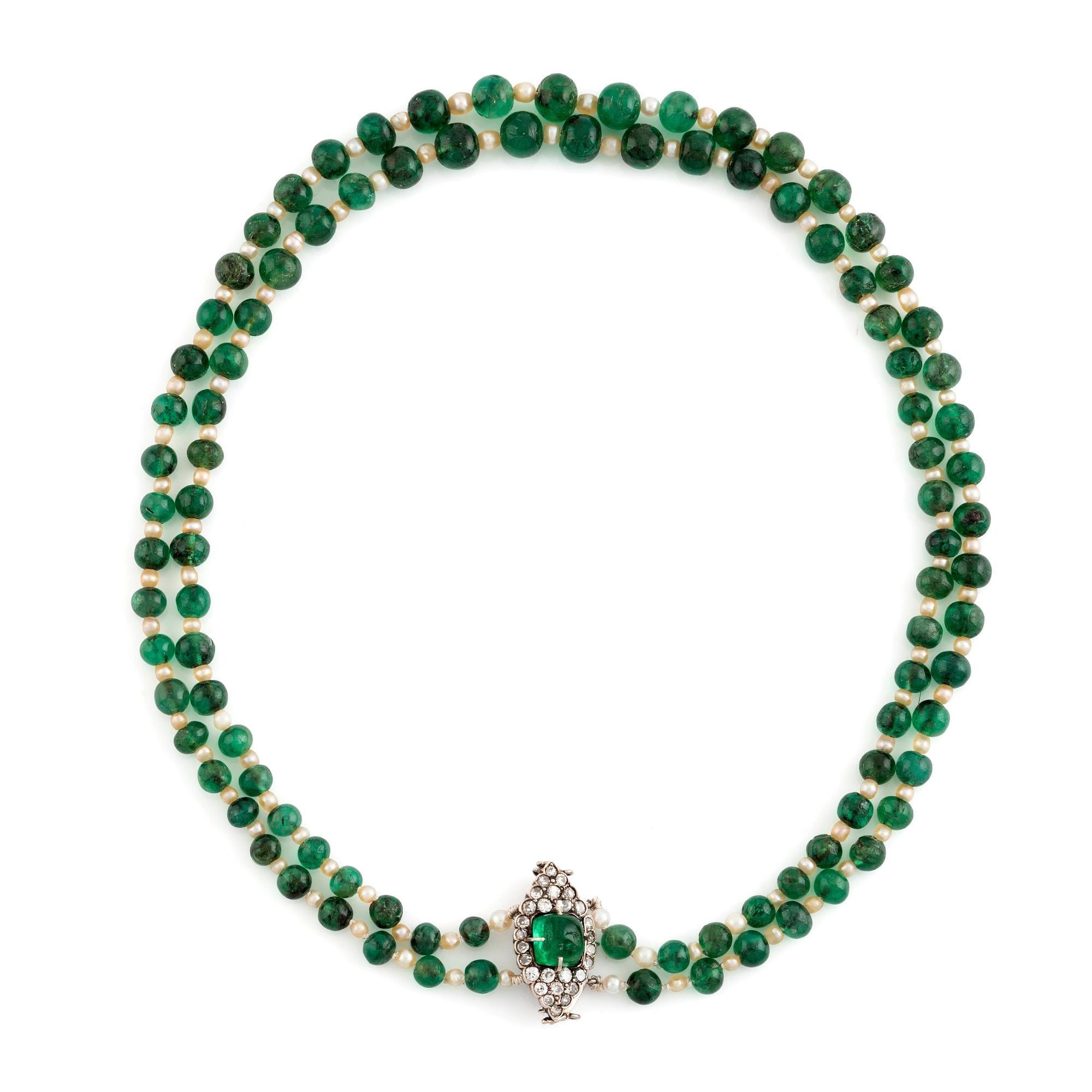 An emerald and pearl necklace with a silver clasp with a cabochon-cut emerald and old-cut diamonds.