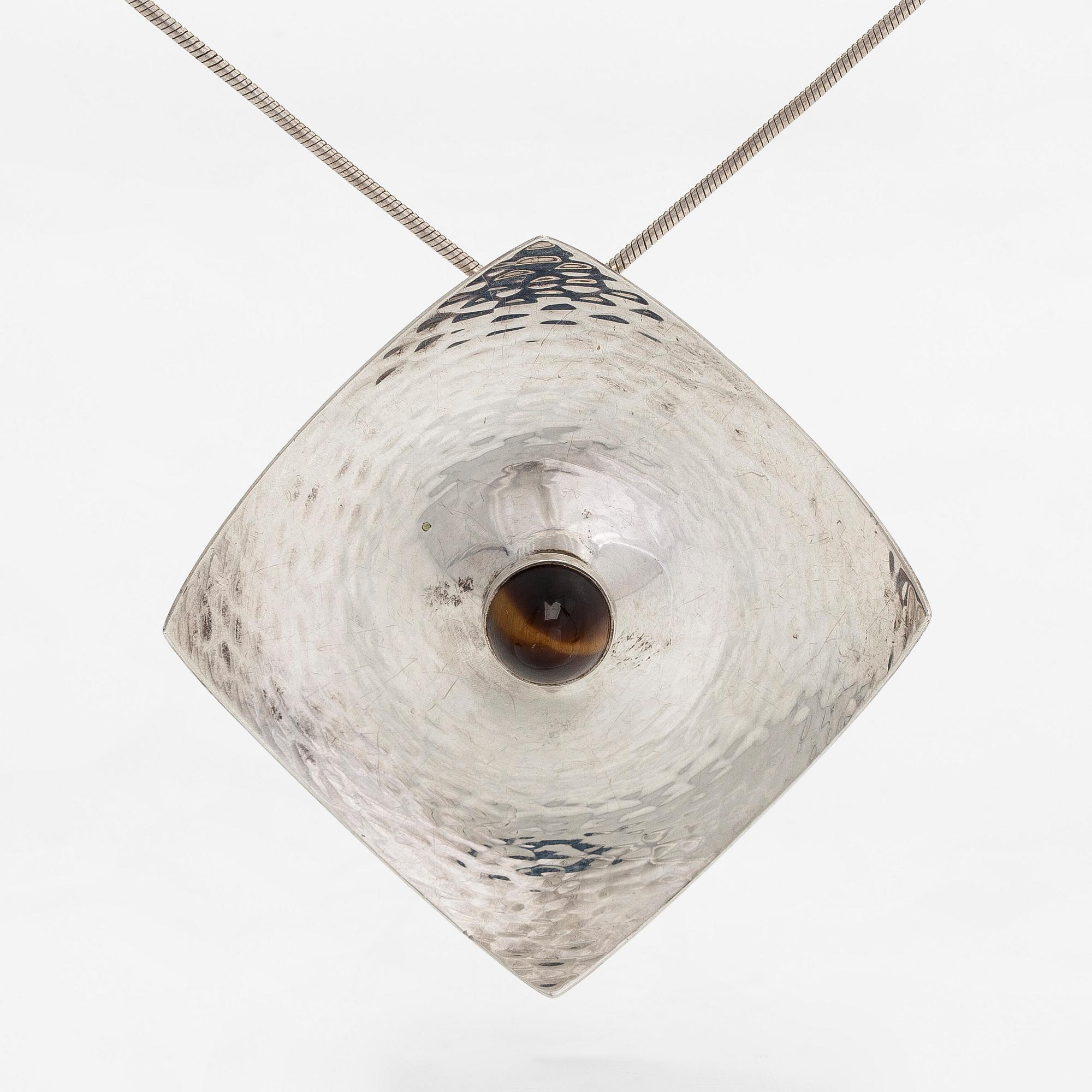 Elis Kauppi, a silver brooch/pendant, and tiger's eye. Kupittaan Kulta, Turku 1962.