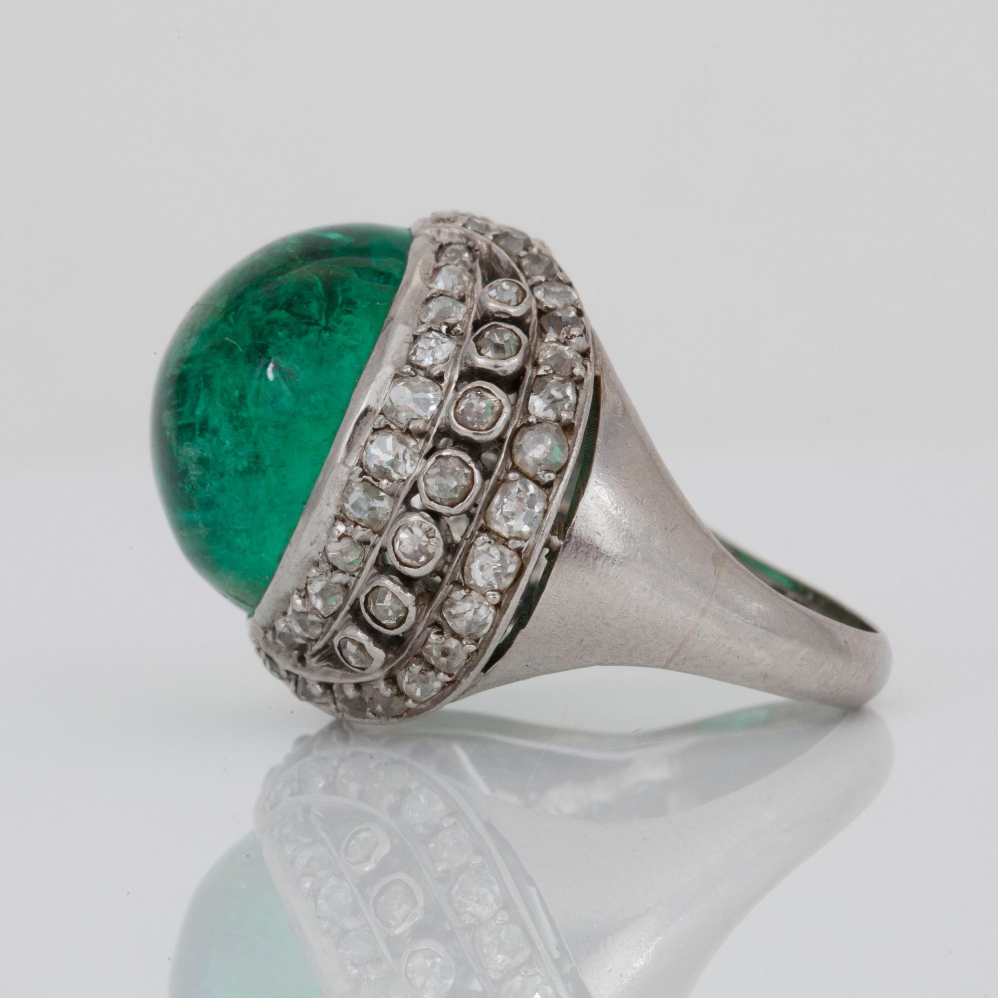 A cabochon-cut emerald and old-cut diamond ring.