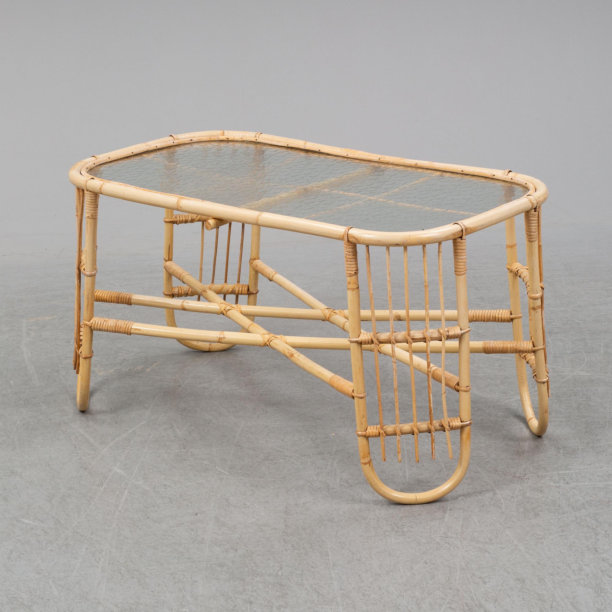 A rattan and glass table and a rattan sofa, second half of the 20th century.