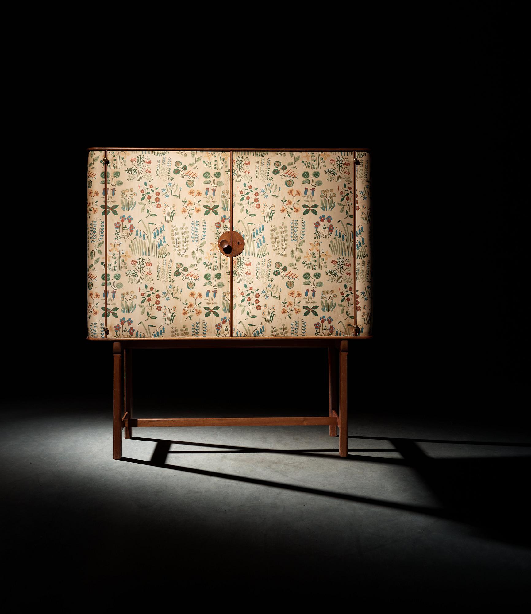 A Josef Frank mahogany cabinet, doors and sides covered in Frank's floral chintz fabric 'Fatima', Svenskt Tenn ca 1937.