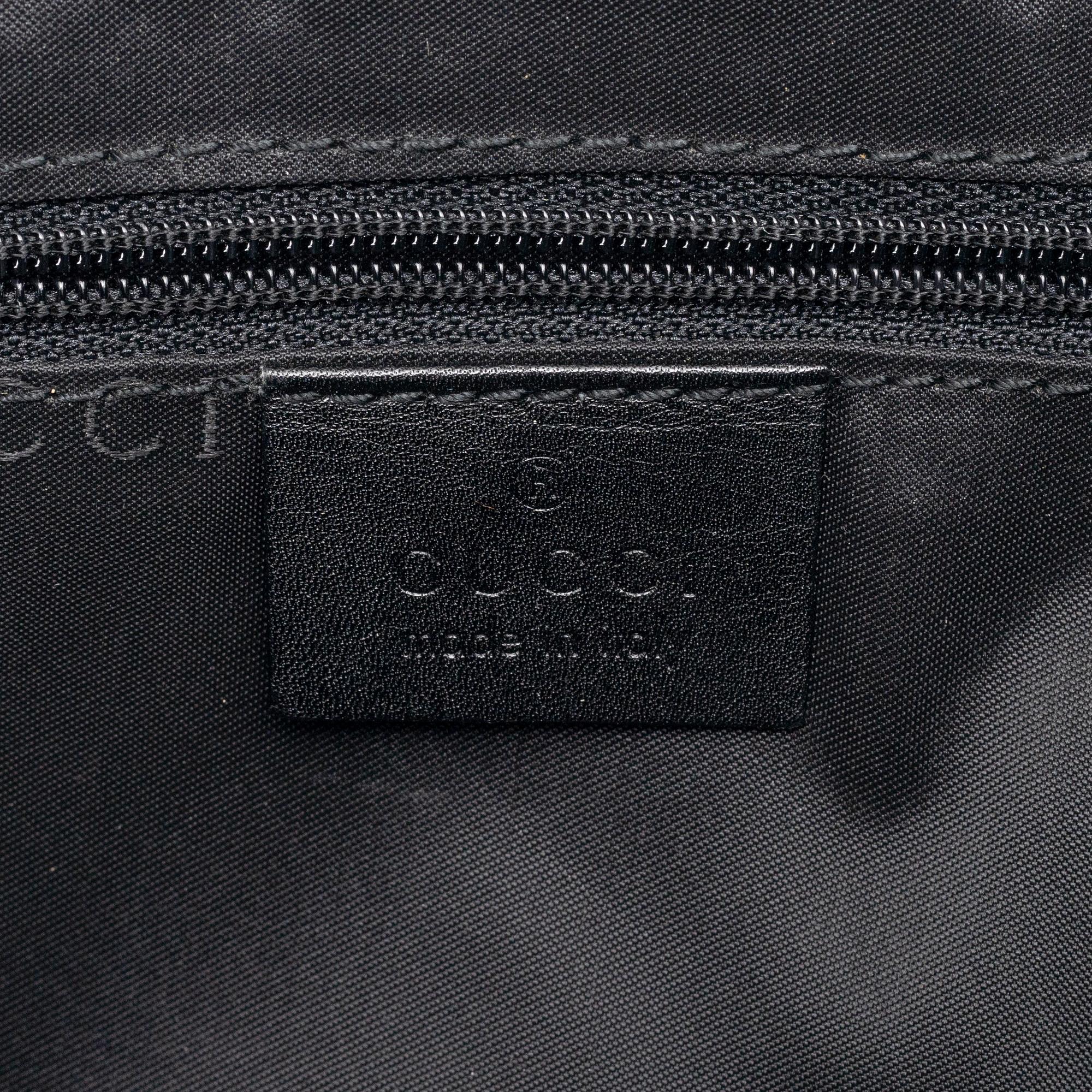 Gucci, a black leather handbag.