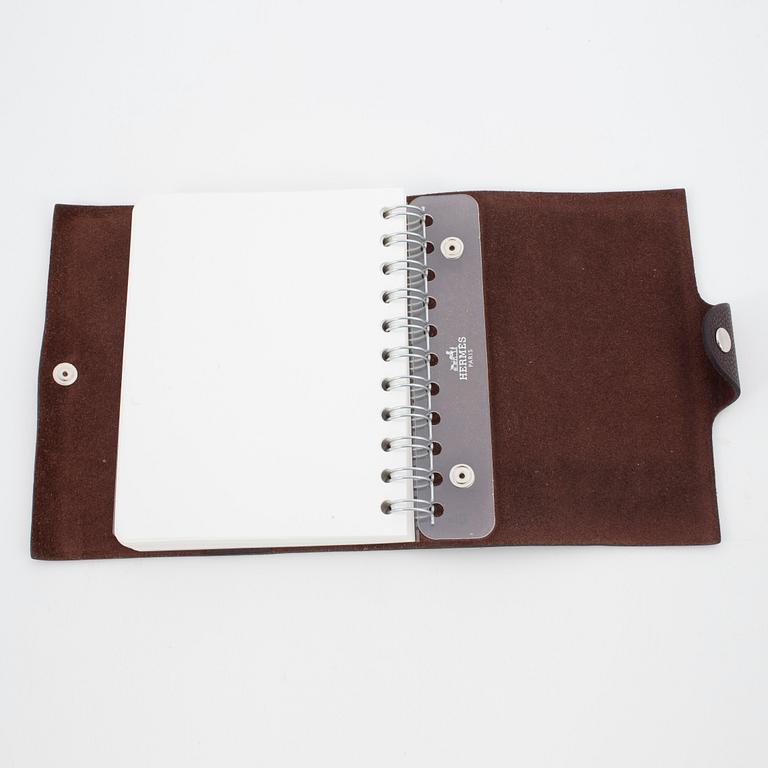 HERMÈS, a brown leather notebook, "Ulysse Petit Modèle".