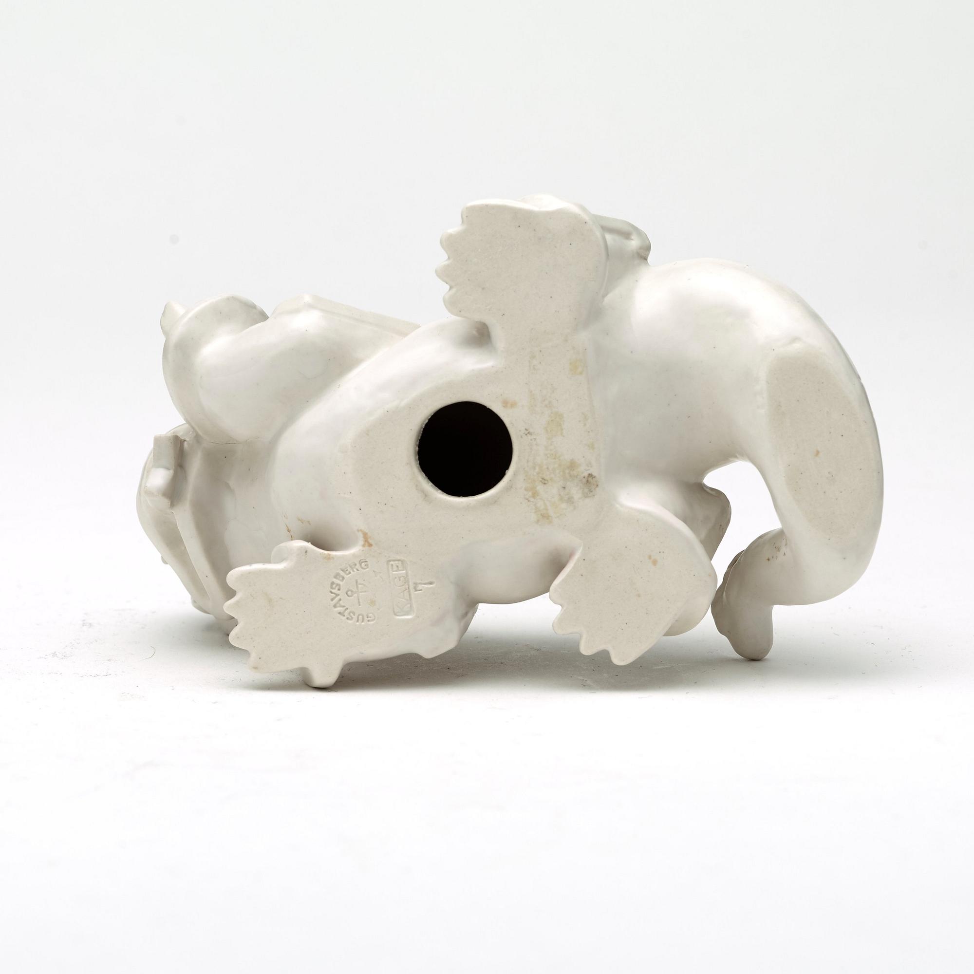 Wilhelm Kåge, a set of stoneware figures of a 'dragon puppy' and two 'dragon puppies' with candle holders, Gustavsberg, ca 1940.