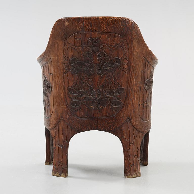 A Gustav Fjaestad Art Nouveau carved pine chair, 'Stabbestol', by Adolf Swanson, Arvika, Sweden 1908.
