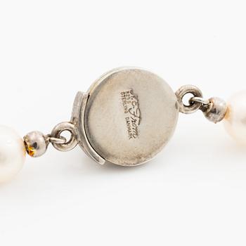 Cultured pearl necklace with Niels Erik From clasp, Denmark, silver set with a green cabochon-cut stone.