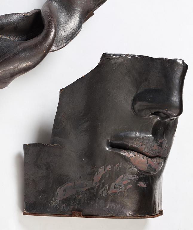 Hertha Hillfon, a black glazed stoneware wall sculpture in two parts of a face and a sky, executed in her own studio, Stockholm 1960s.