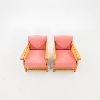 A pair of lacquered wood and rattan easy chairs from the middle of the 20th century.