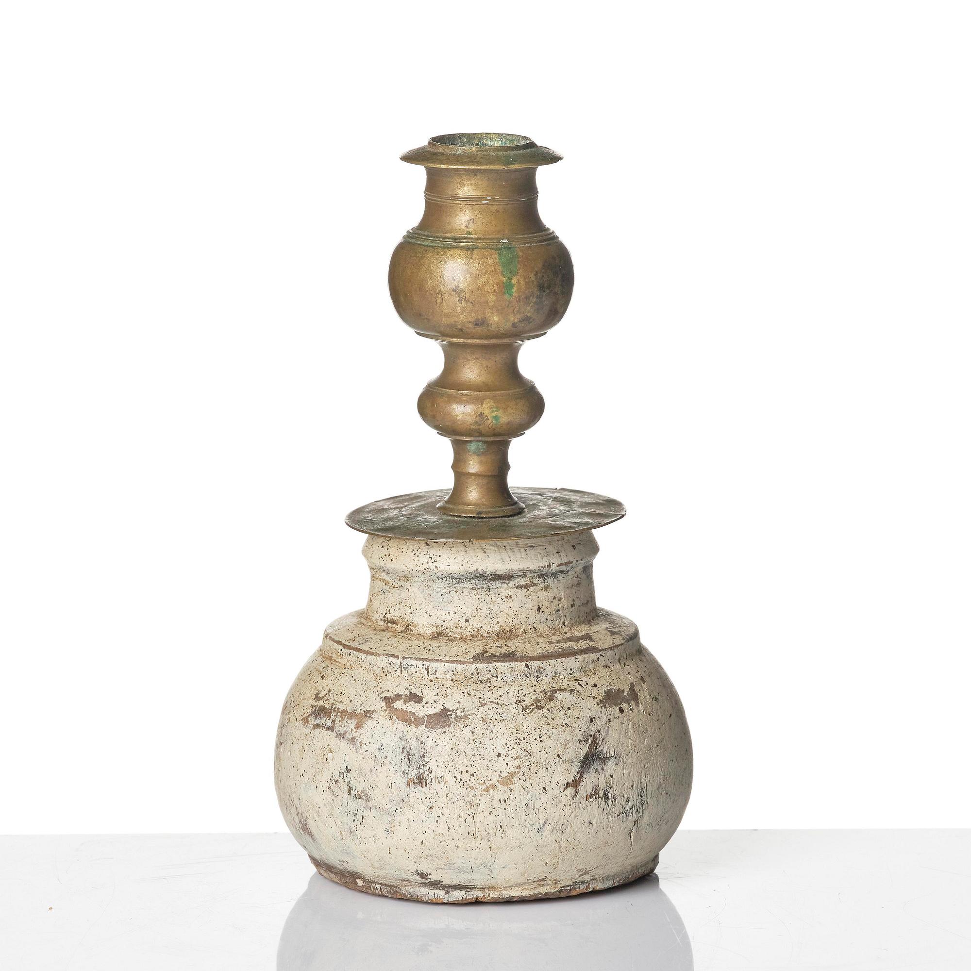 A Northern European baroque candlesticks, late 17th century, with a repaired wooden base.