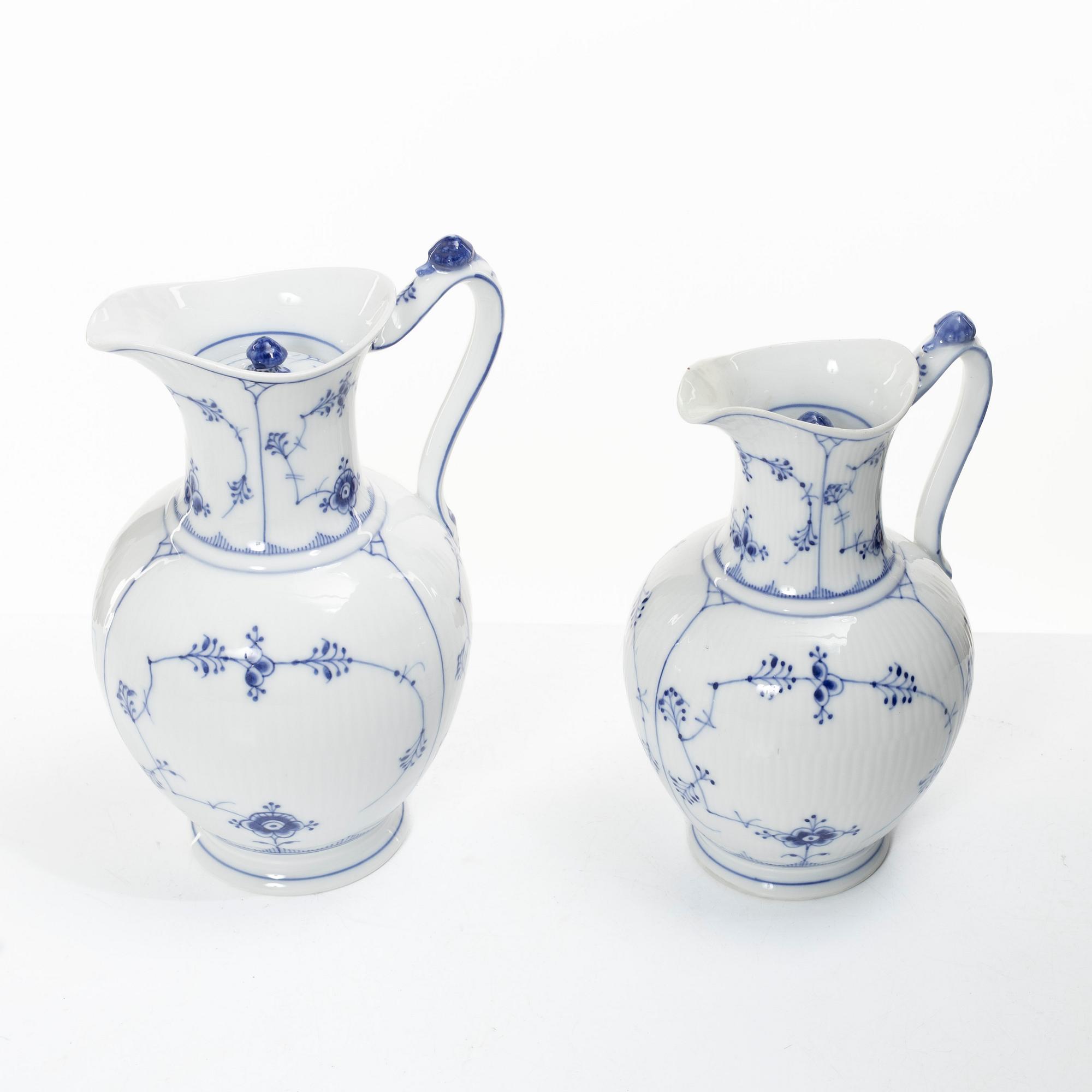 Royal Copenhagen, Three 'Musselmalet' jugs, circa 1900, and a Bing & Grøndahl cachepot, Denmark.