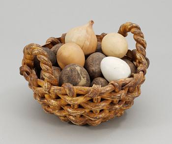 An Ingrid Herrlin stoneware basket with potatos, onion and eggs, Båstad.