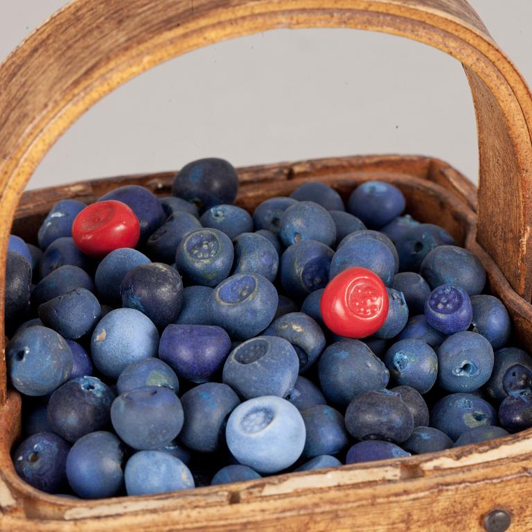 An Ingrid Herrlin stoneware blueberry basket with two lingonberries, Båstad, Sweden.