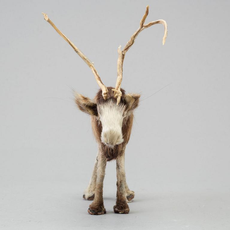 A Sami reindeer fur figure of a reindeer.