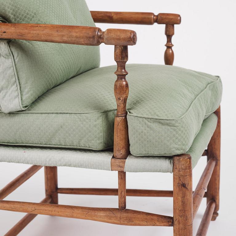 A pair of Gustavian 'Gripsholm' armchairs and an ottoman by J. Hammarström (master 1794-1812).