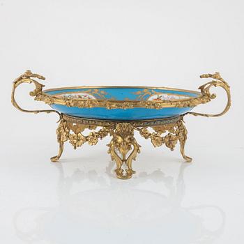 A French porcelain and brass centrepiece, second half of the 19th Century.