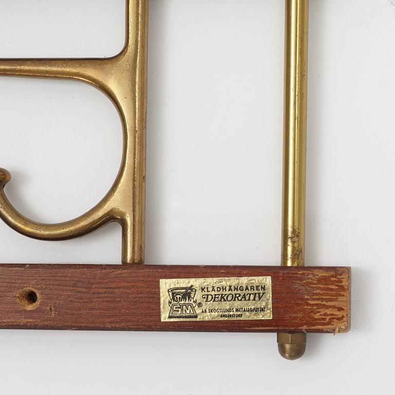 Two 'Dekorativ' coat hangers, Skogslunds metallgjuteri, Anderstorp, mid 20th Century.