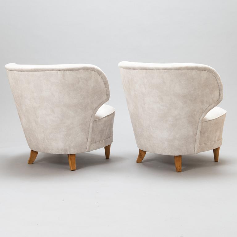 A pair of mid-20th-century armchairs.