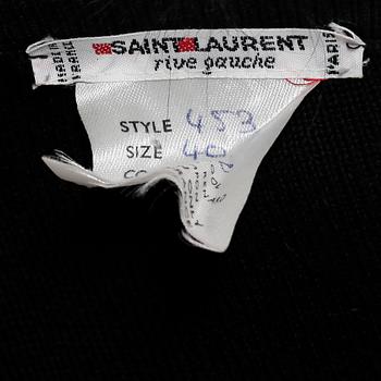 YVES SAINT LAURENT, a black wool sweater with fox pompons.