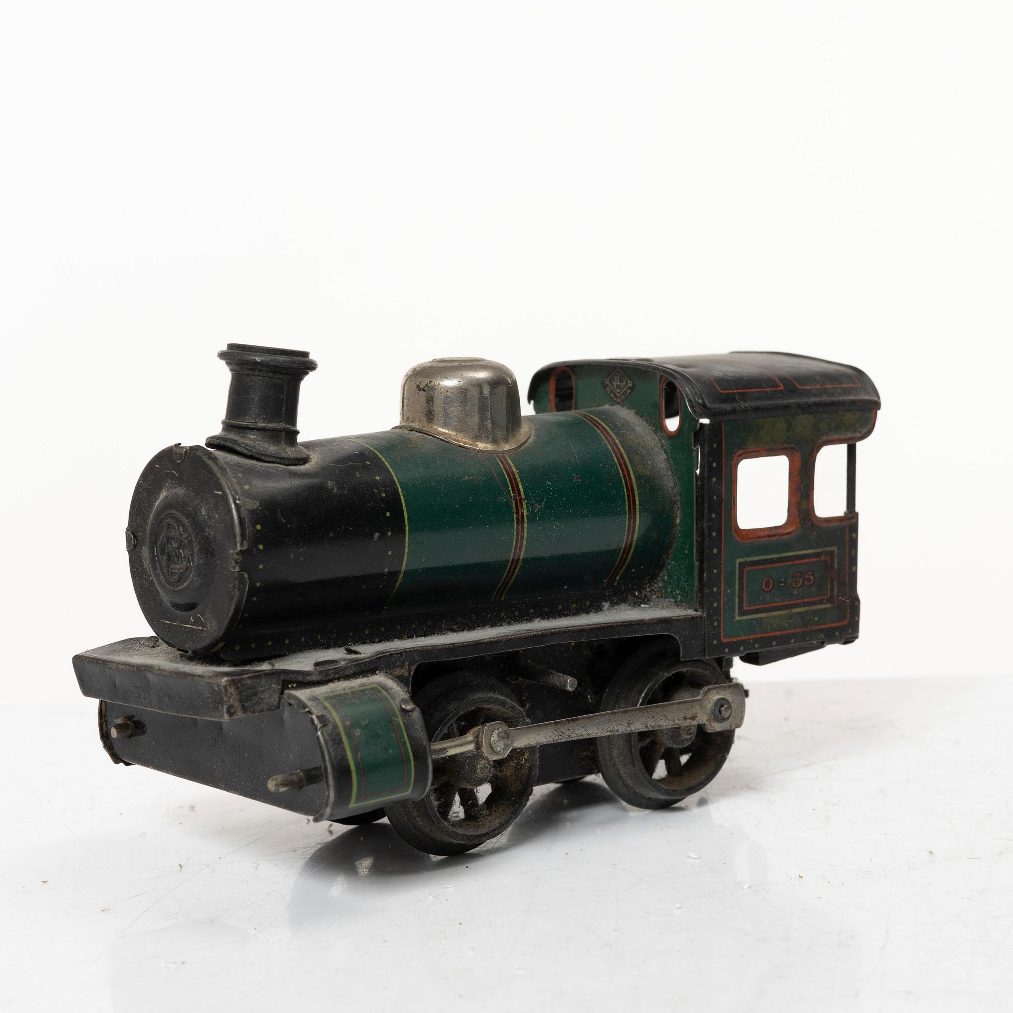 Model train with track and station building, 13 pieces, Germany, 1920s.